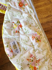 Floral-patterned fabric with a visible brand label on a wooden surface