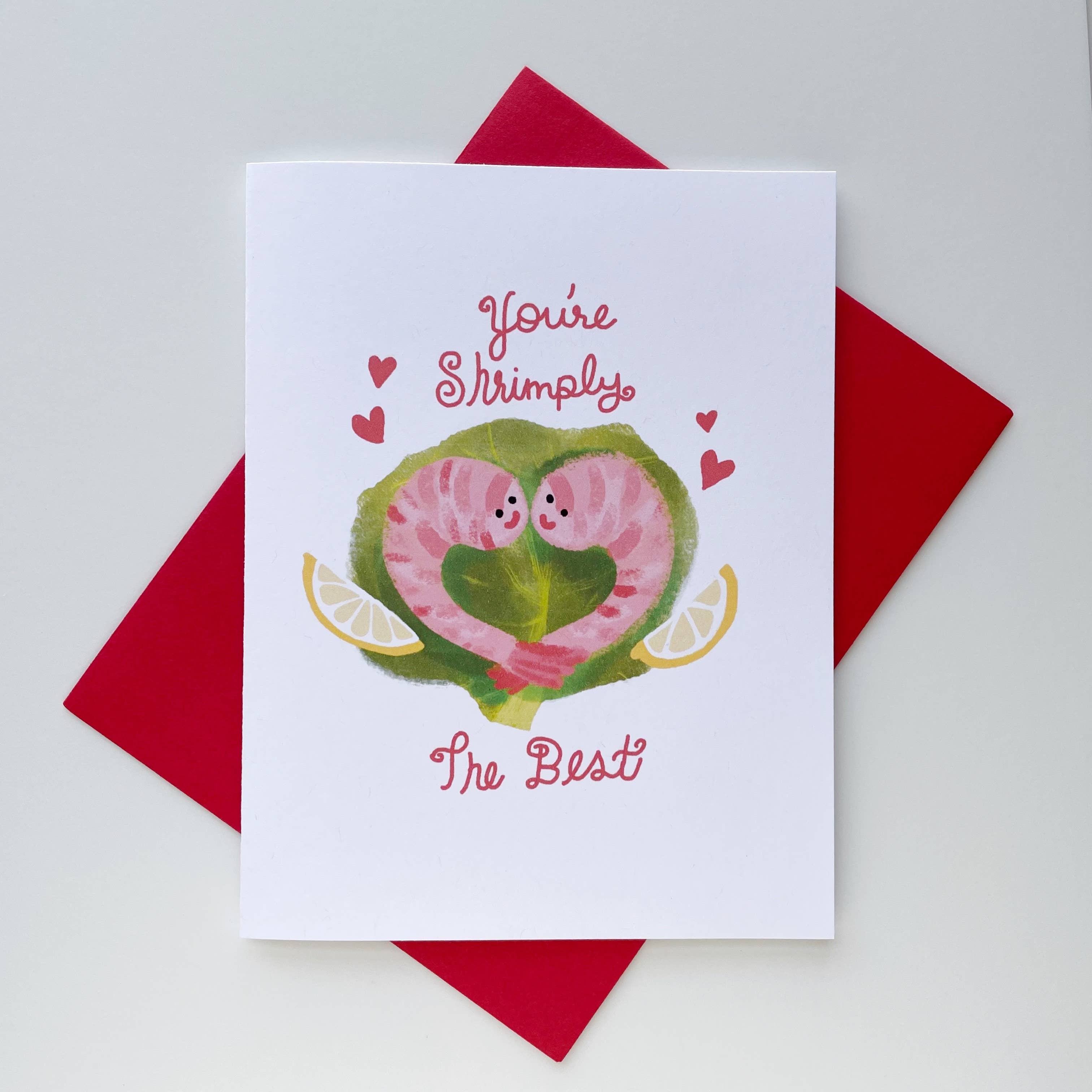 Greeting card with cartoon worms forming a heart on a red envelope