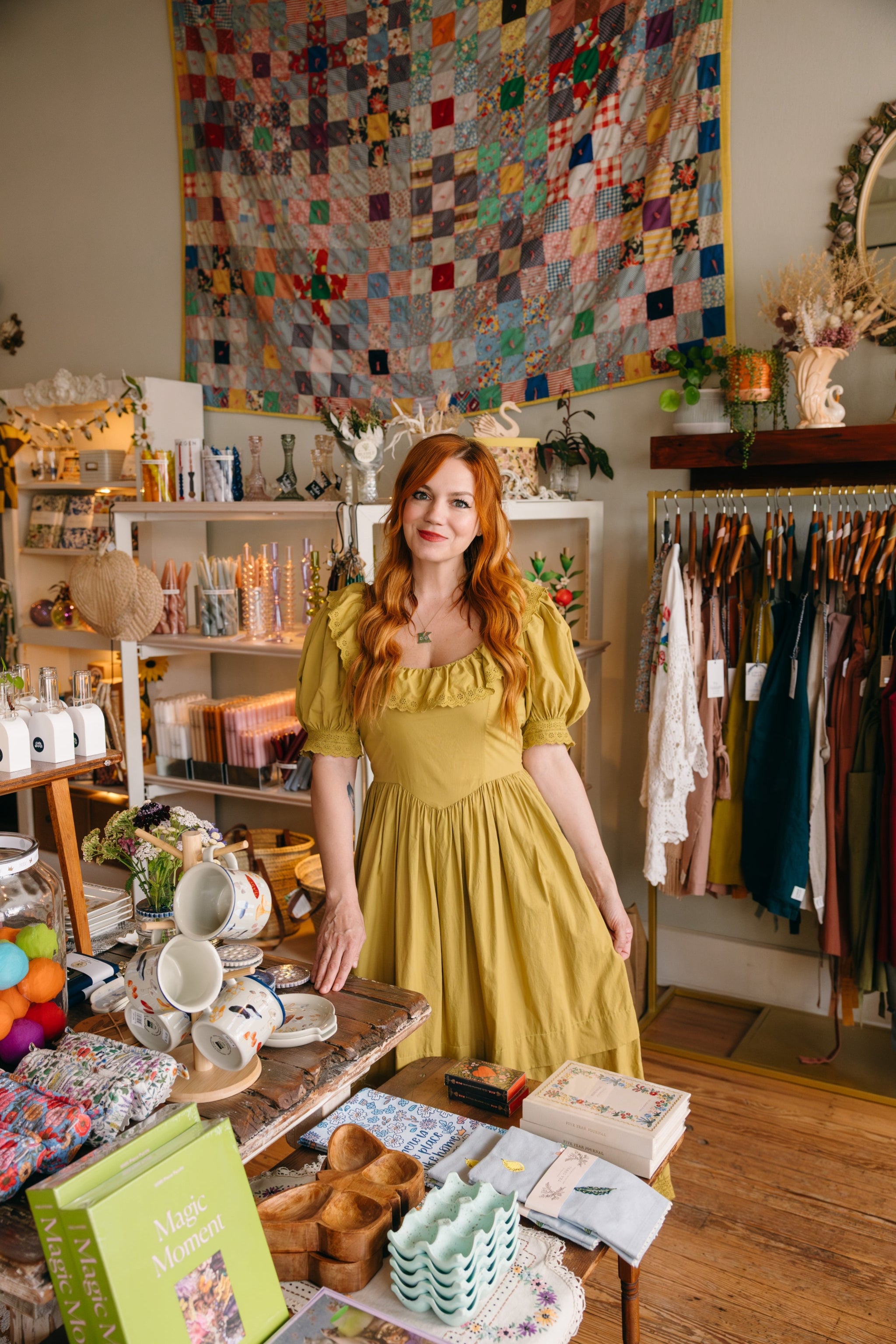 Katie Shelton, owner of Springfield Mercantile Co. in a yellow dress standing in her store with home goods and handmade aprons around her.

Description: Image of owner, Katie Shelton, of Springfield Mercantile Co. sharing our story to customers on the about page. 
Keywords: Springfield Mercantile Co., About Us, Historic Commercial St, store owner Katie Shelton image, online shop, Shopify
