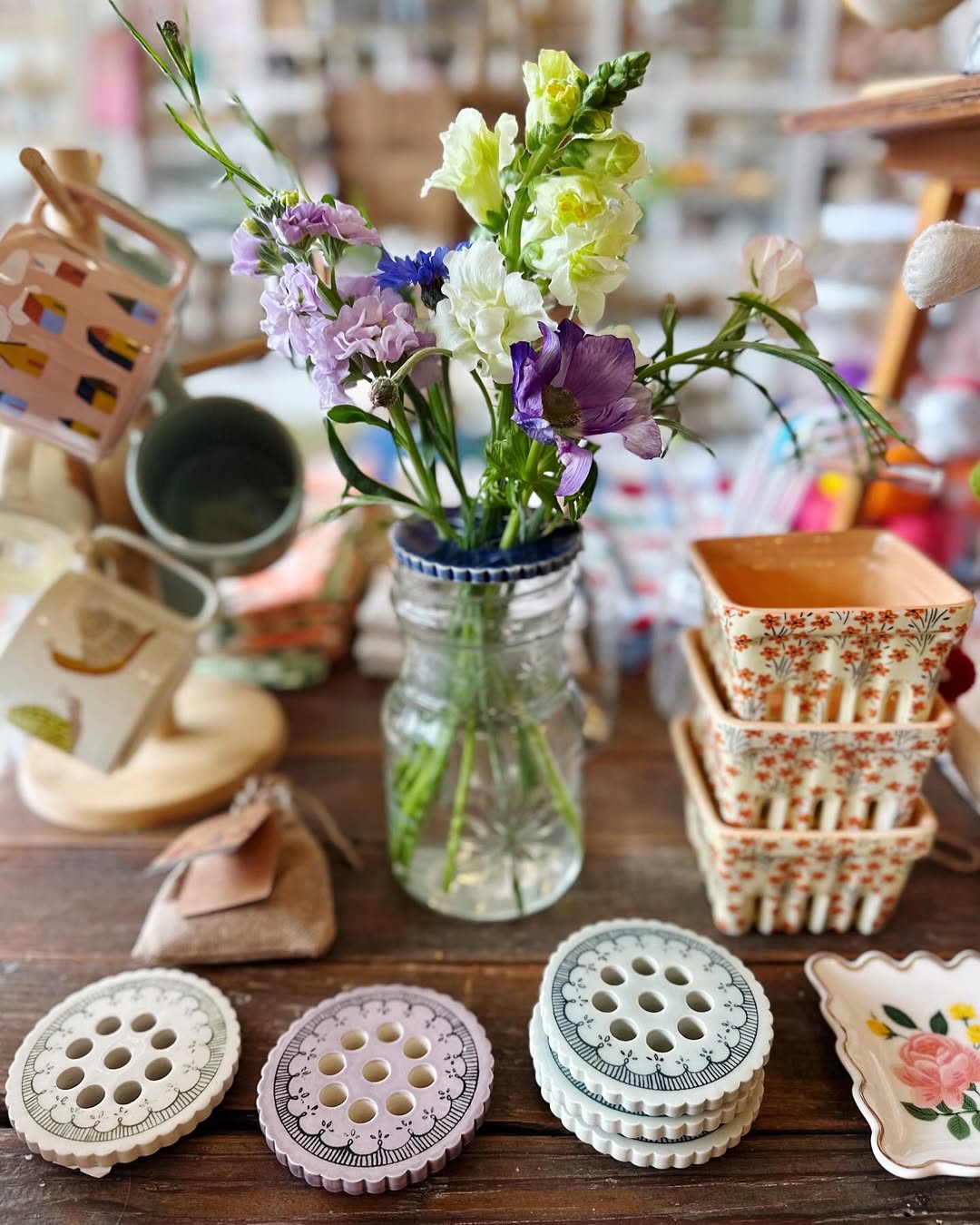 Image of Springfield Mercantile Co. interior showing Home Decor goods with flowers on an antique table on the about page. 
Keywords: Springfield Mercantile Co., About Us, Peek Into Our Shop, Home Decor, home decor goods with flowers on an antique table image, online shop, Shopify
