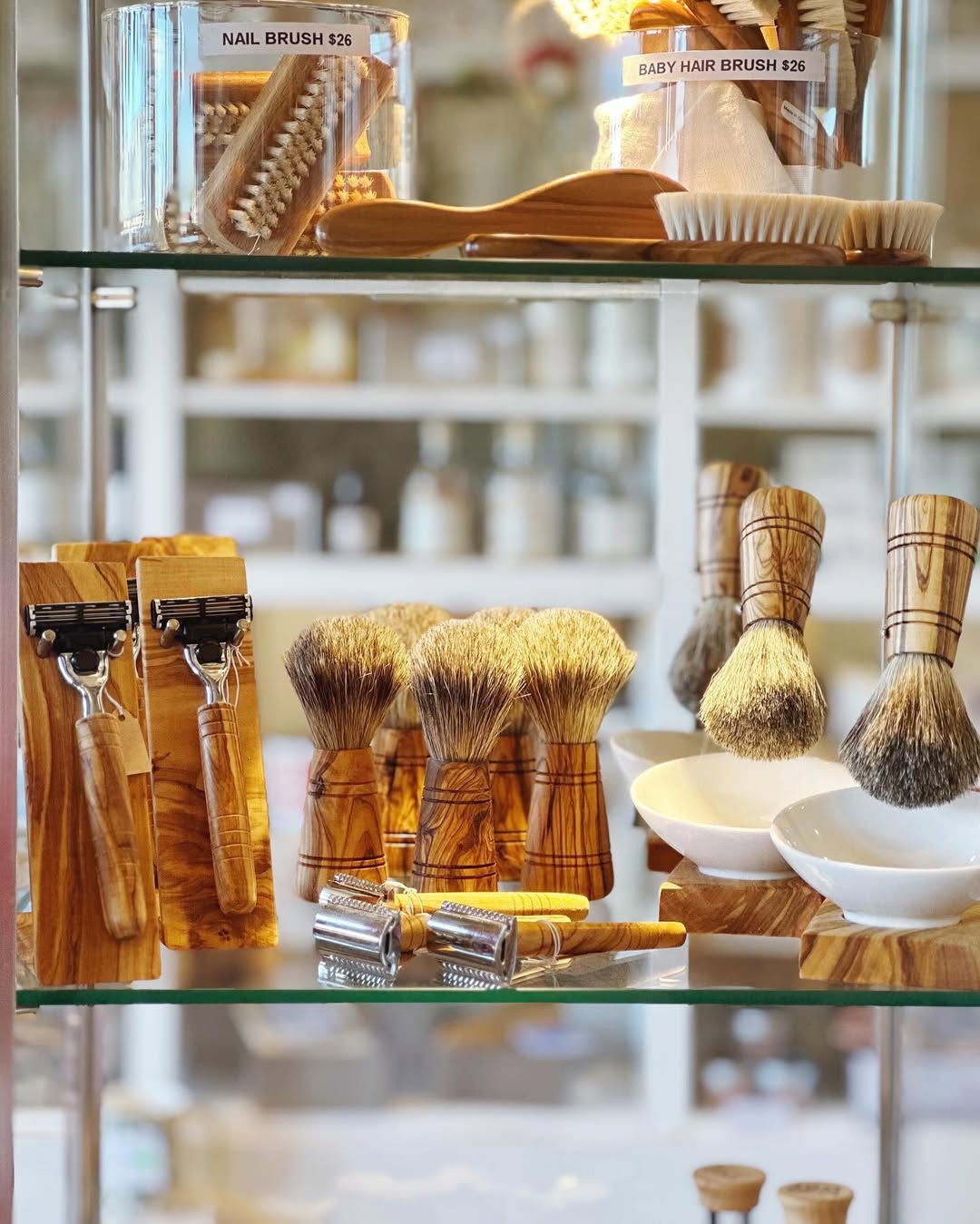 Image of Springfield Mercantile Co. interior showing Classic Brushes, Razors and Cleaning goods on glass shelves on the about page. 

Keywords: Springfield Mercantile Co., About Us, Peek Into Our Shop, Brushes &amp; Cleaning, classic brushes and razors on glass shelves image, online shop, Shopify
