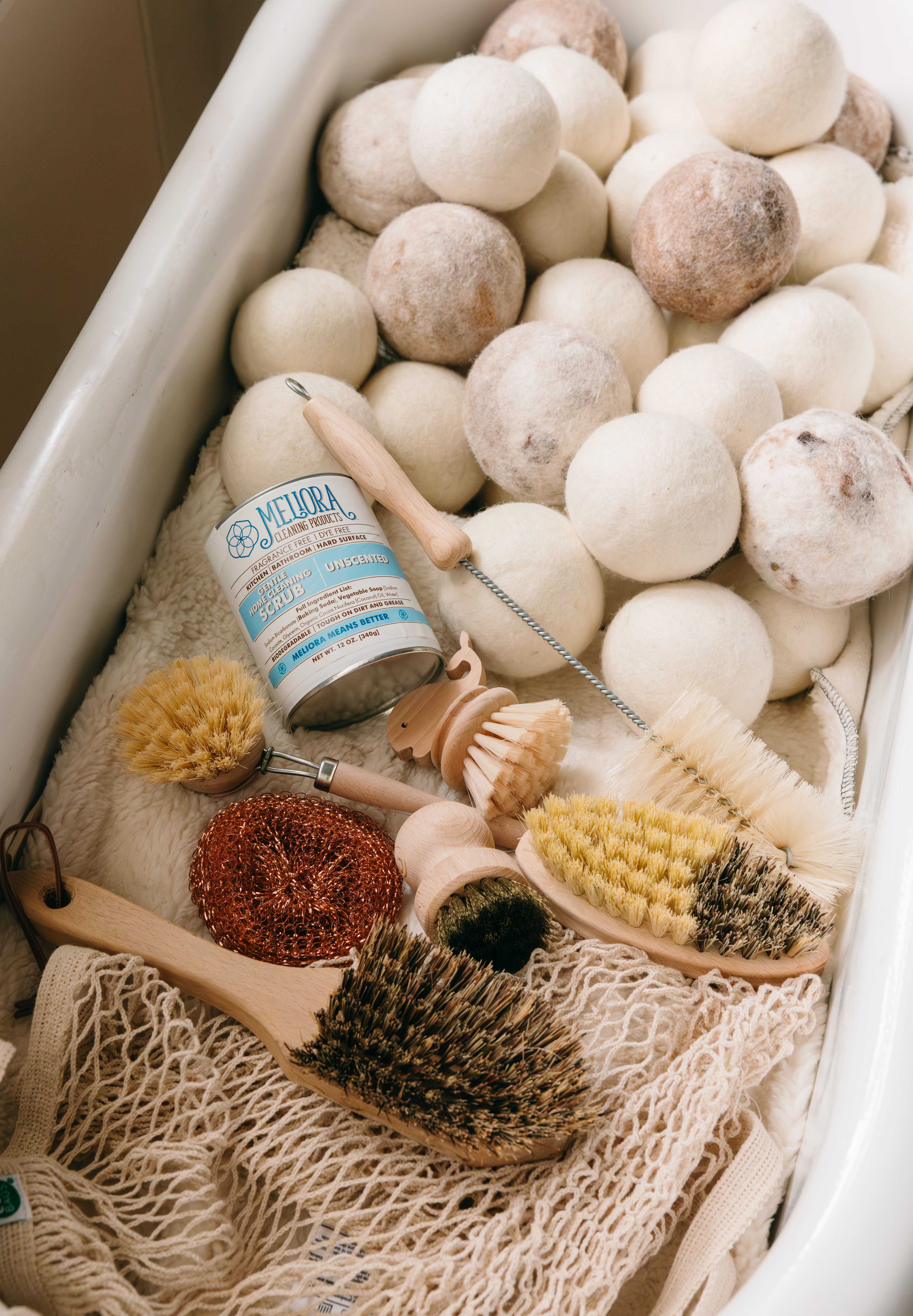 Collection of eco-friendly cleaning tools including wool dryer balls, natural brushes and a mesh bag in an antique bathtub.

Description: Sliding image card promoting Eco-Friendly goods on the Springfield Mercantile Co. homepage. 
Keywords: Springfield Mercantile Co., eco-friendly, sliding image card, online store, Shopify