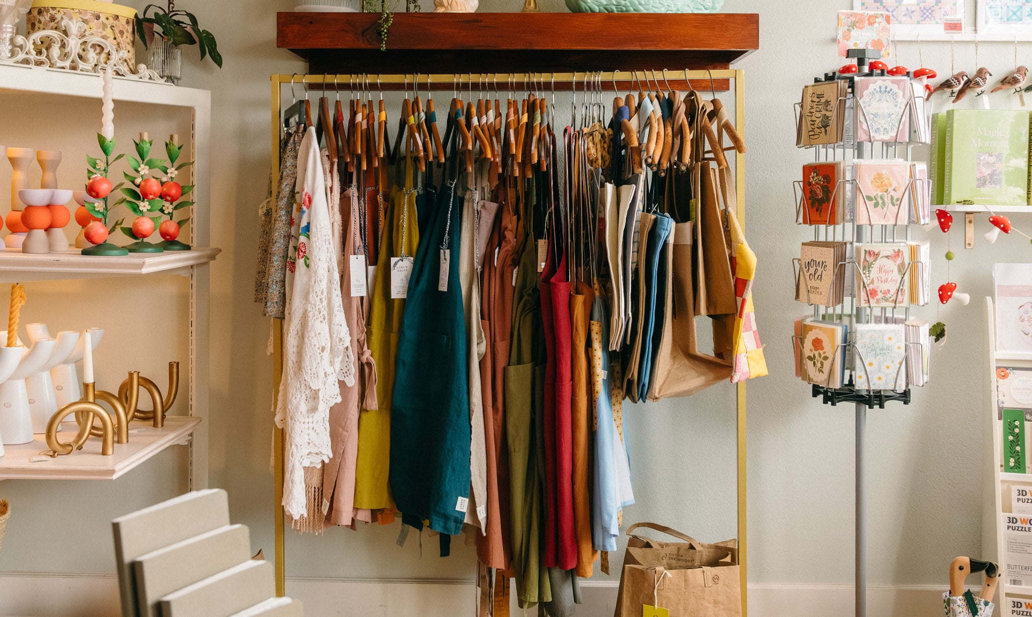 Clothing rack with various colorful aprons and handmade totes in Springfield Mercantile Co. on Historic Commercial Street in Springfield Missouri.