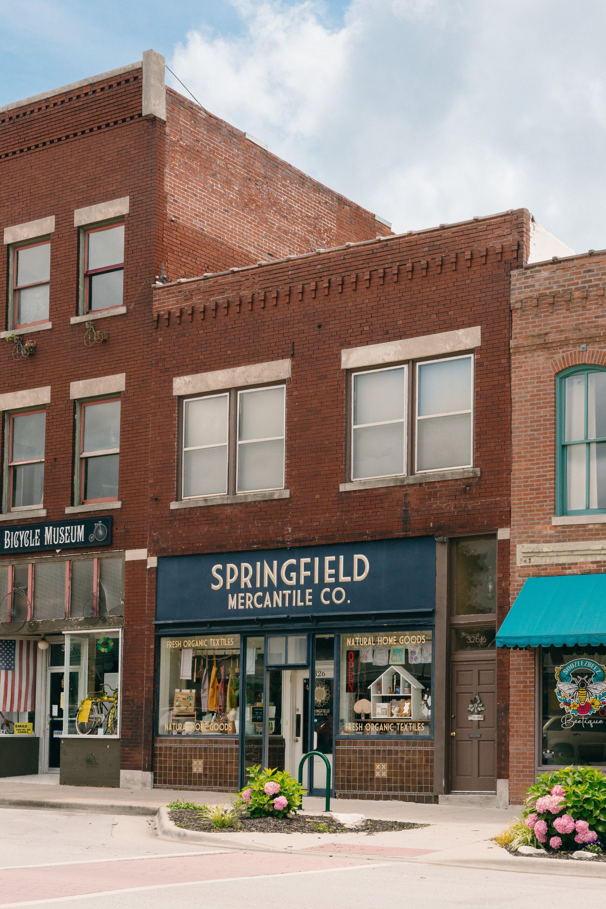 Brick building with 'Springfield Mercantile Co.' sign on historic Commercial Street in Springfield, Missouri.

Description: Mobile image of Springfield Mercantile Co. storefront asking customers to Visit Us on Historic Commercial St. on the homepage. 
Keywords: Springfield Mercantile Co., Visit Us, Historic Commercial St, storefront image, online shop, Shopify

