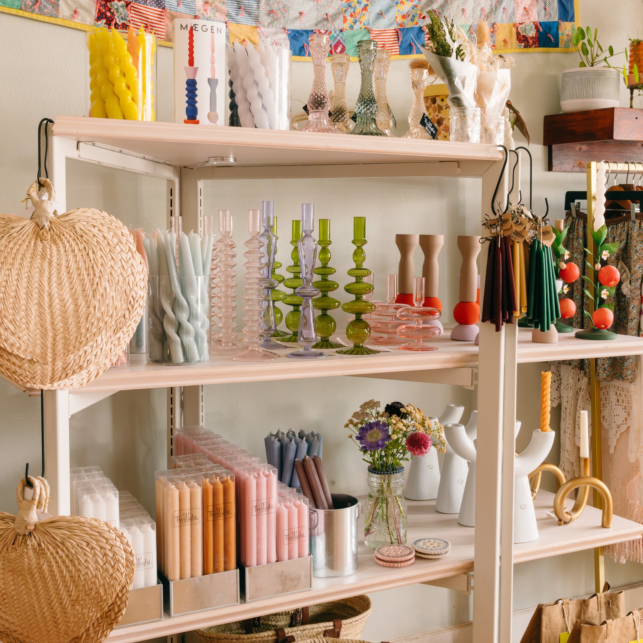 Shelf with decorative items including a colorful quilt, candles and baskets inside Springfield Mercantile Co. A home goods shop on Historic Commercial Street in Springfield, MO.

Description: Special collections image promoting Best Selling on the Springfield Mercantile Co. homepage. 
Keywords: Springfield Mercantile Co., best selling, collections section, online shop, Shopify
