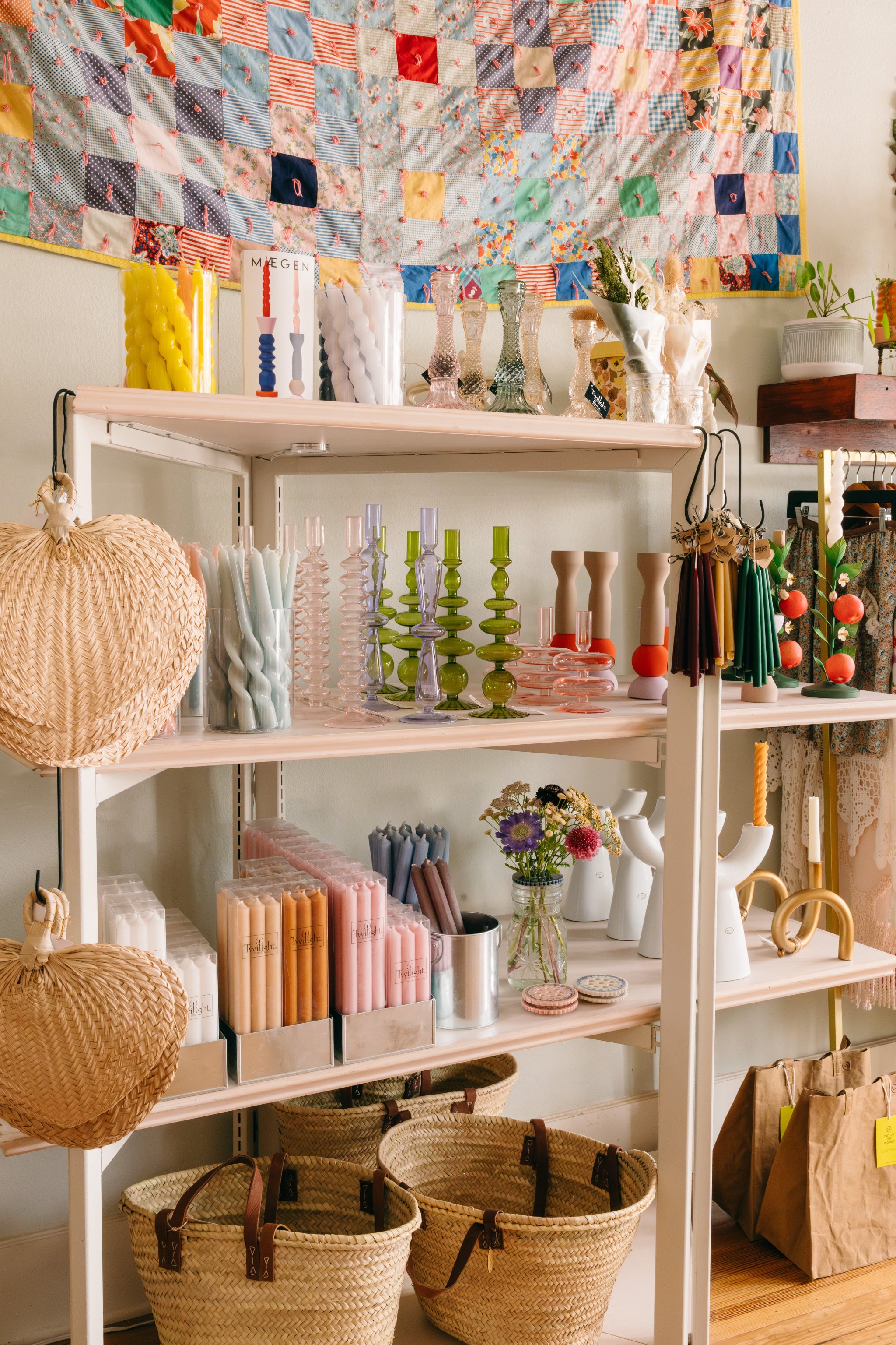 Shelf with decorative items including a colorful quilt, candles and baskets inside Springfield Mercantile Co. A home goods shop on Historic Commercial Street in Springfield, MO.

Description: Special collections image promoting Best Selling on the Springfield Mercantile Co. homepage. 
Keywords: Springfield Mercantile Co., best selling, collections section, online shop, Shopify
