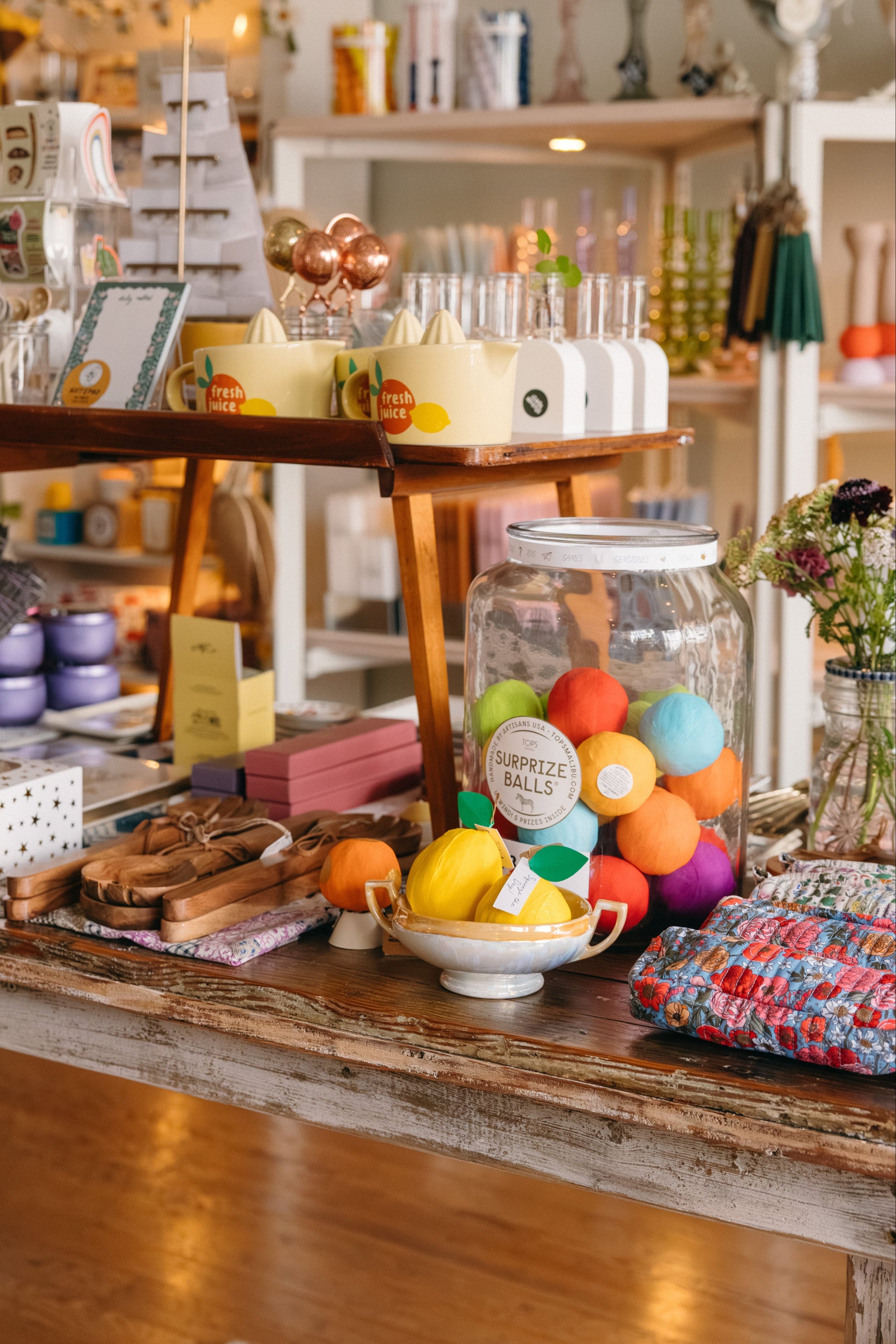 Vintage-style store interior with wooden table, colorful home goods, and shelves in the background.

Description: Special collections image promoting New Arrivals on the Springfield Mercantile Co. homepage. 
Keywords: Springfield Mercantile Co., new arrivals, collections section, online boutique, Shopify
