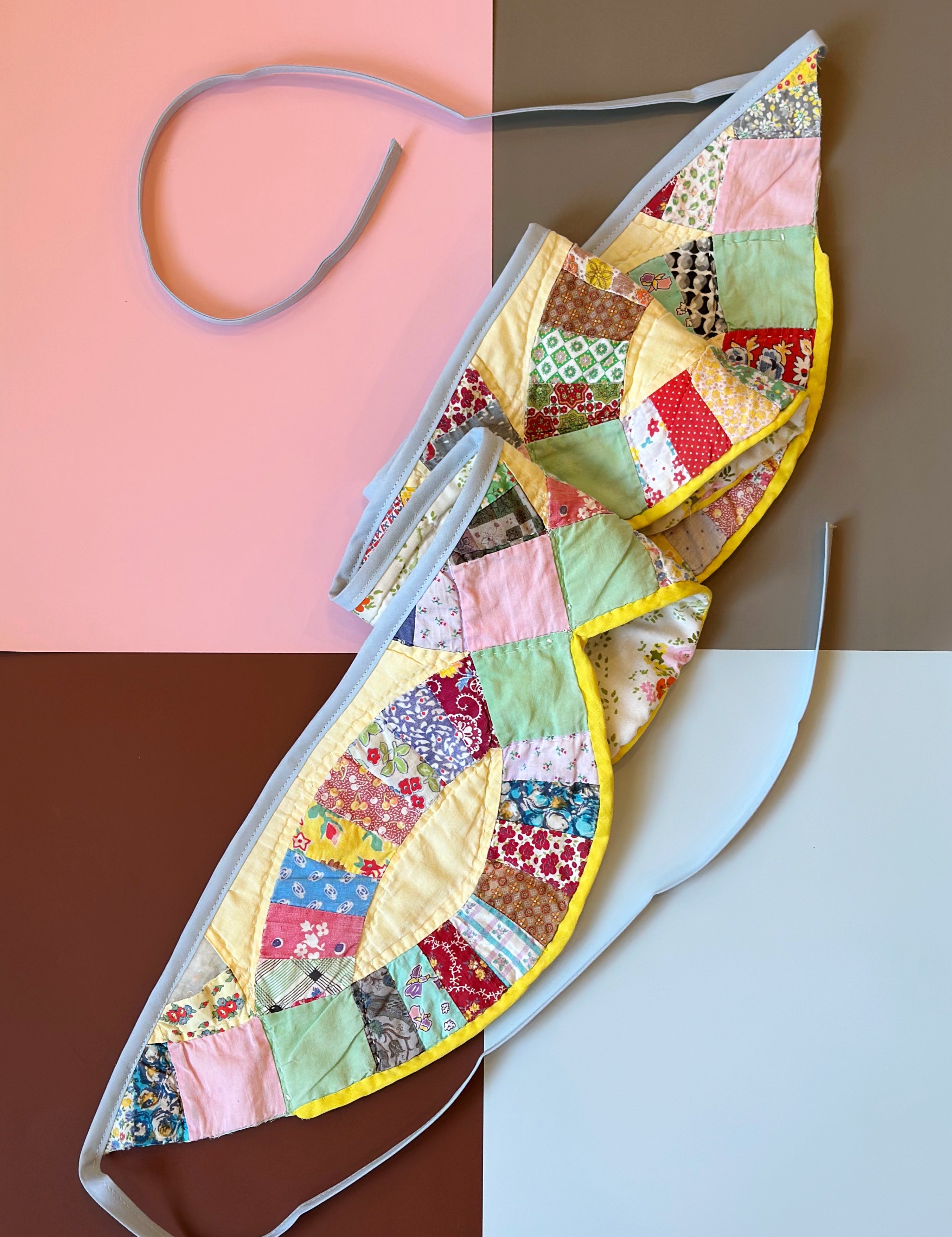 Colorful patchwork bunting with floral patterns on a multicolored background