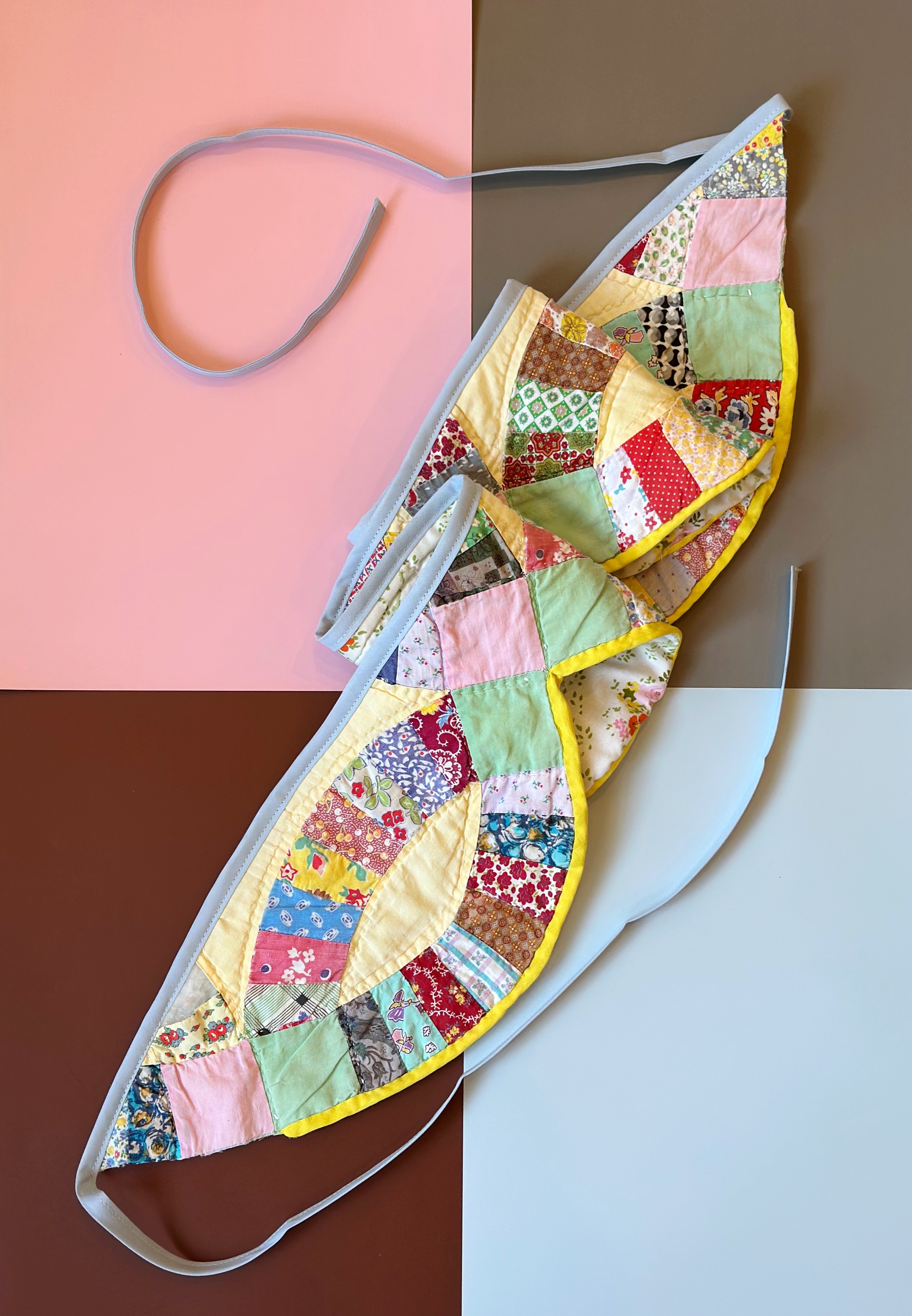 Colorful patchwork bunting with floral patterns on a multicolored background