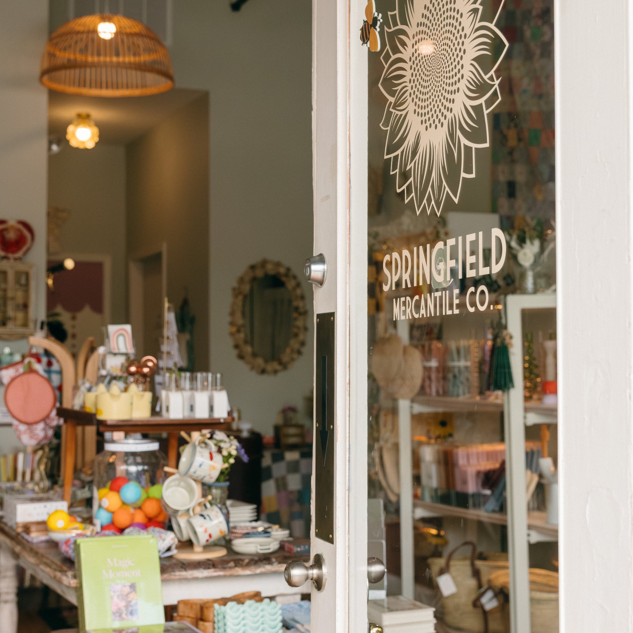 Store interior with an inviting open glass door displaying 'Springfield Mercantile Co.' in Springfield Missouri.