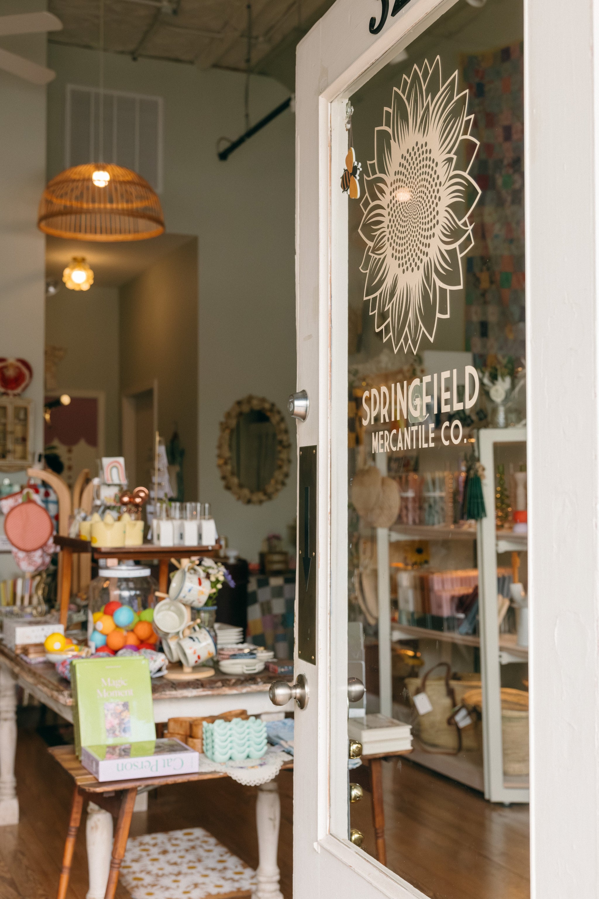 Store interior with an inviting open glass door displaying 'Springfield Mercantile Co.' in Springfield Missouri.