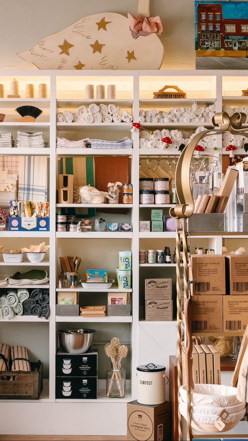 Store interior showing shelves stocked with cozy home goods and a display area inside Springfield Mercantile Co. in Springfield, Missouri.